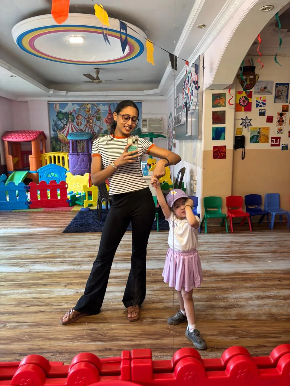 Vidushi Rajoria leading a movement activity with a child at Little Cambridge