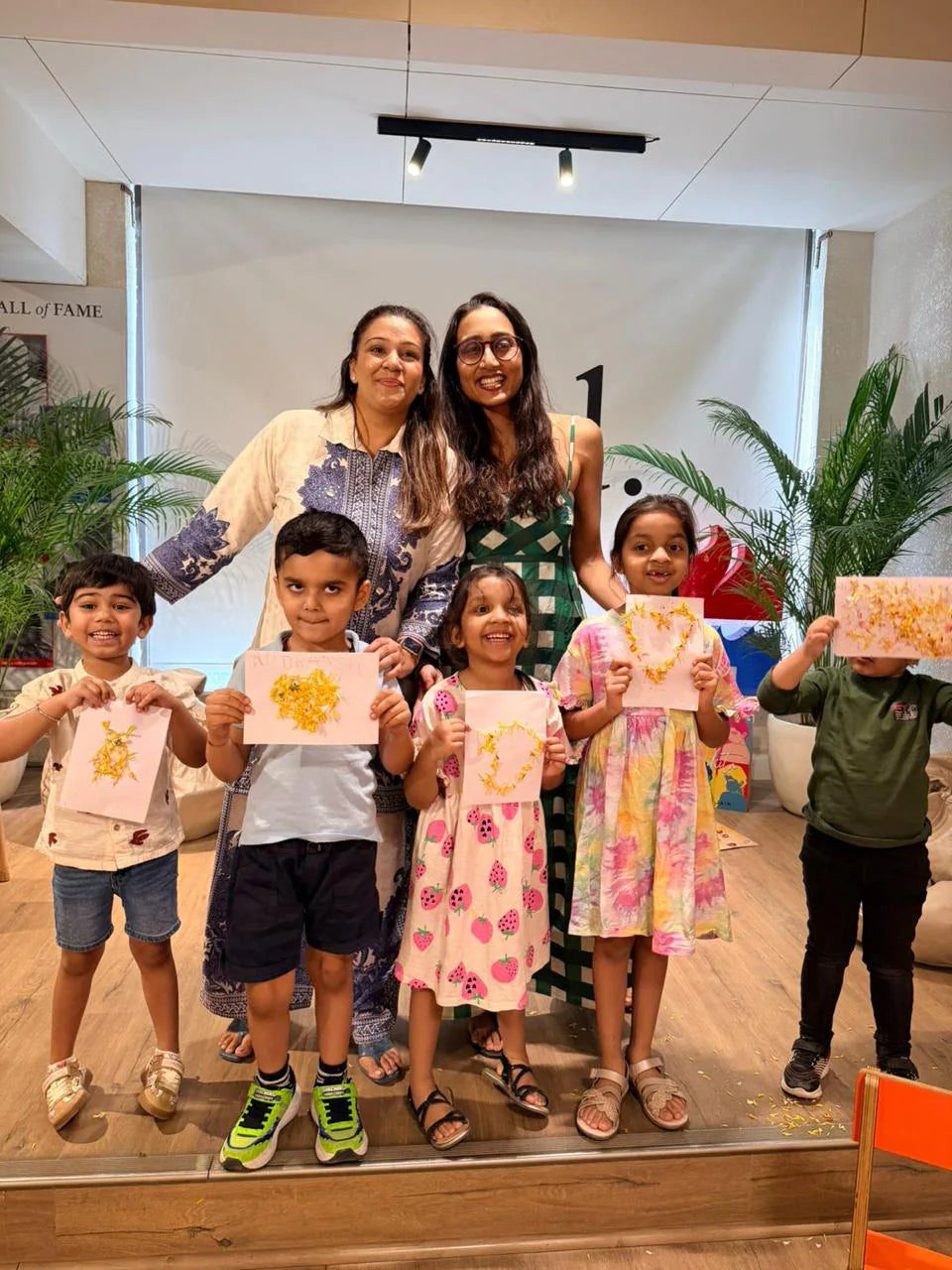Vidushi Rajoria with Little Cambridge children holding their artwork