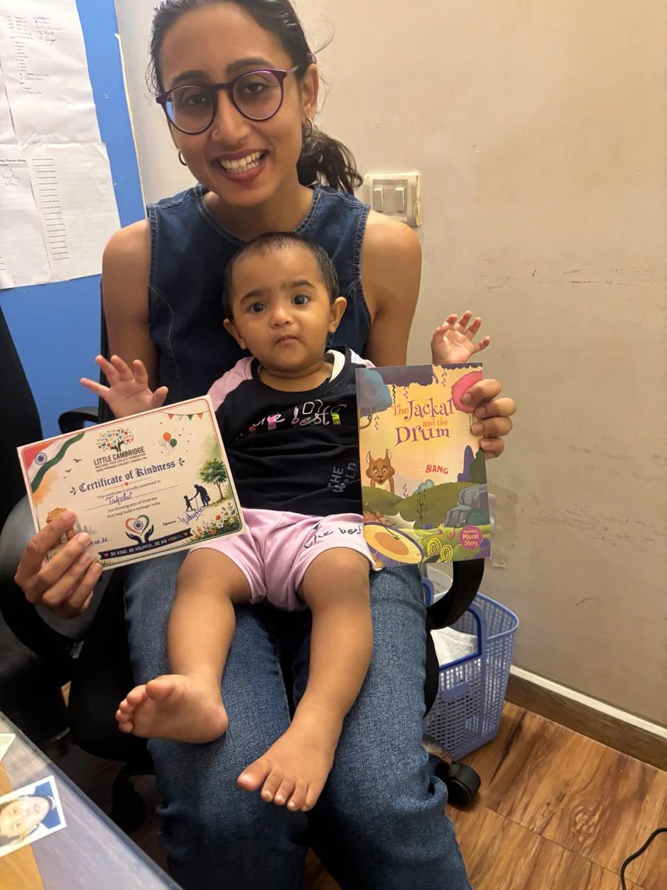 Vidushi Rajoria sharing a book and certificate moment with a young learner at Little Cambridge